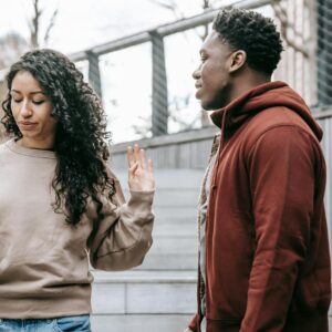 multiethnic couple arguing on street