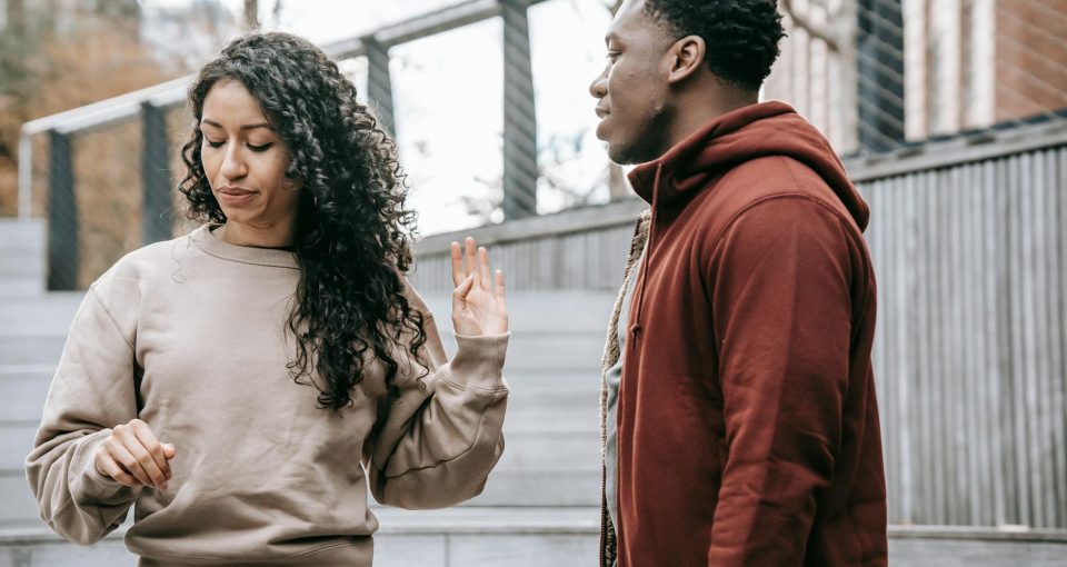 multiethnic couple arguing on street
