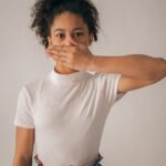 worried black girl covering mouth