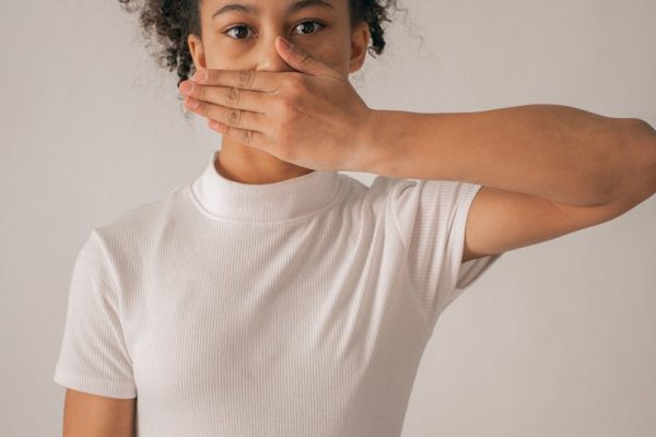 worried black girl covering mouth