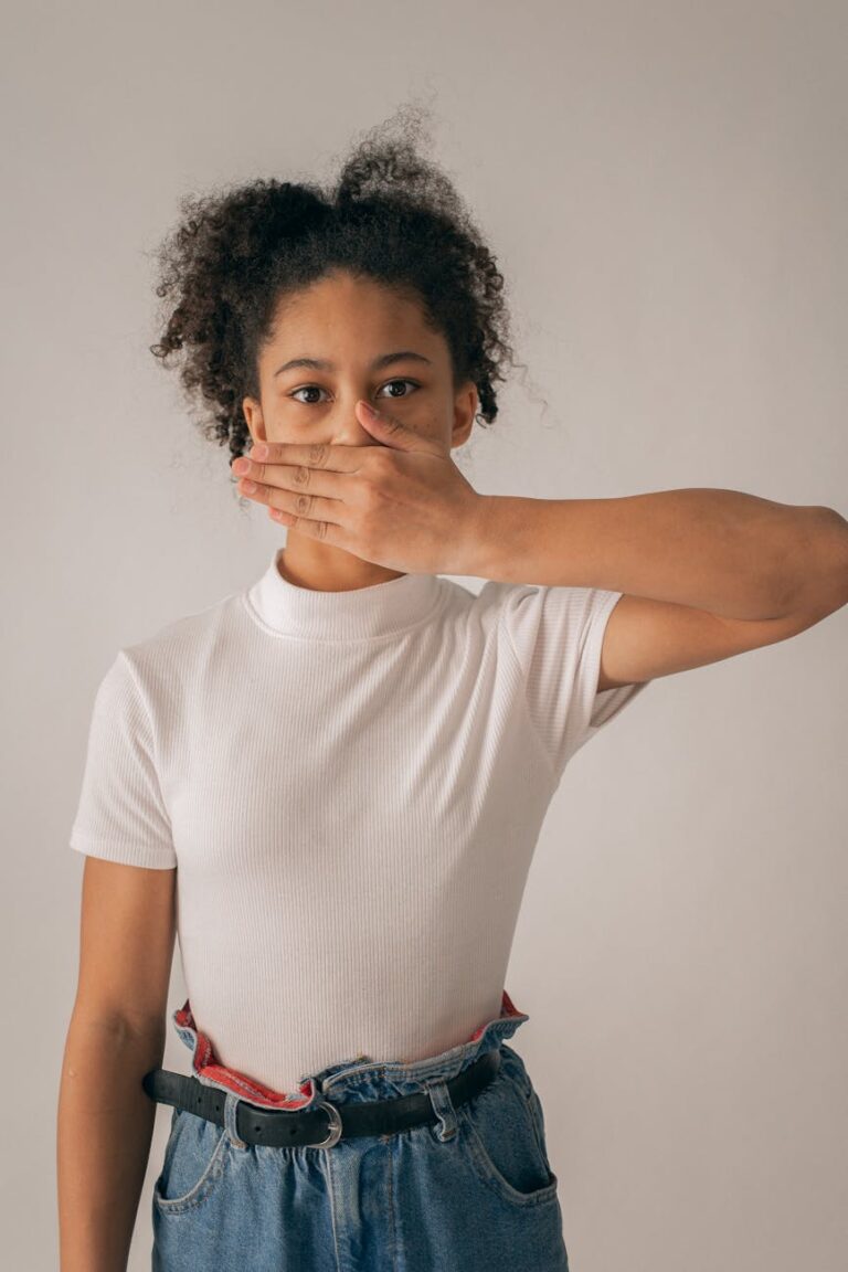 worried black girl covering mouth